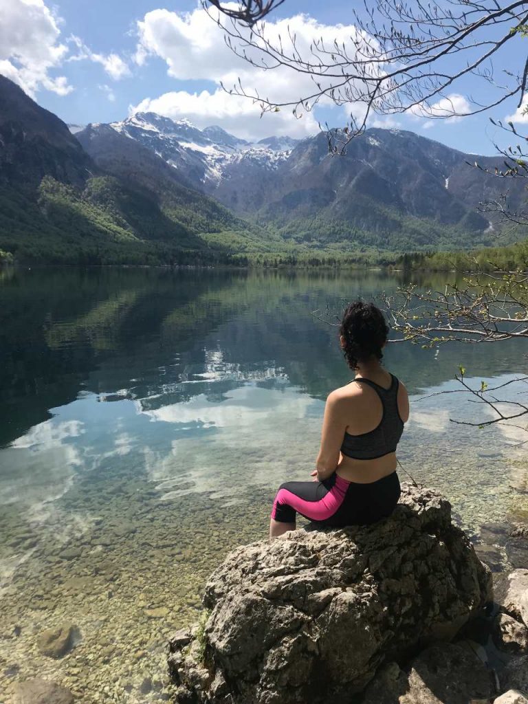 Sitting on a rock at lake bohinj Slovenia
