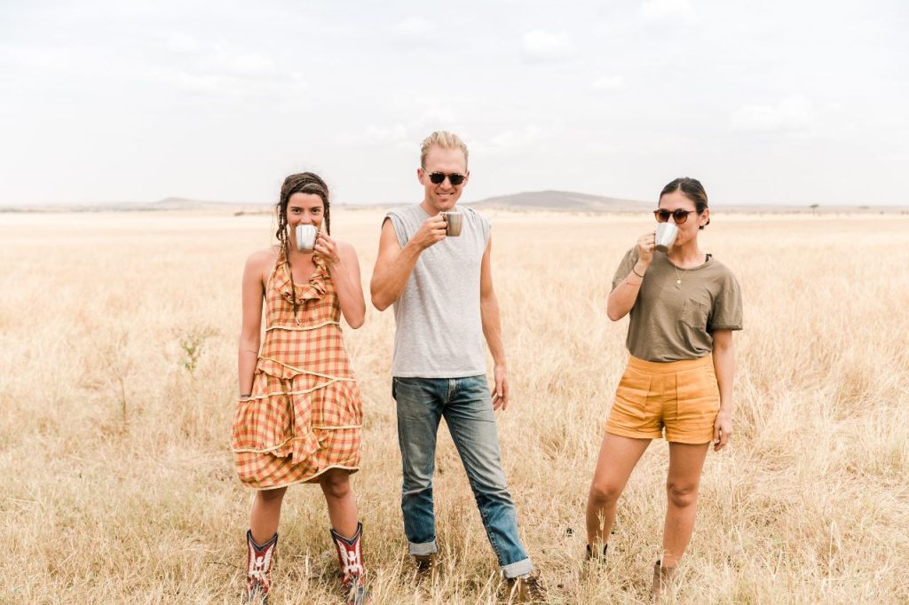 3 tourists drinking tea at Cottars safaris in Kenya